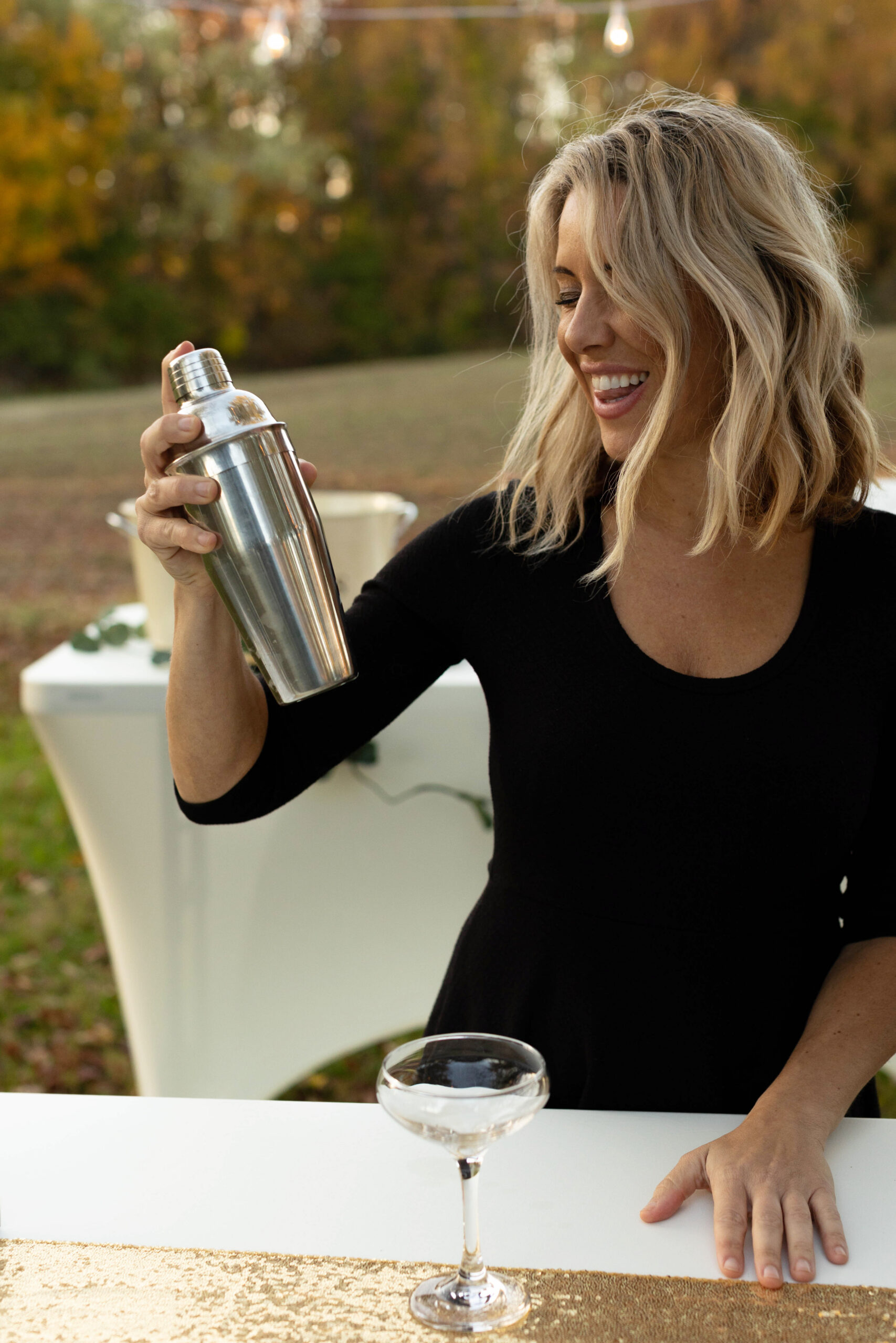 Courtney Smith shaking a martini at an event